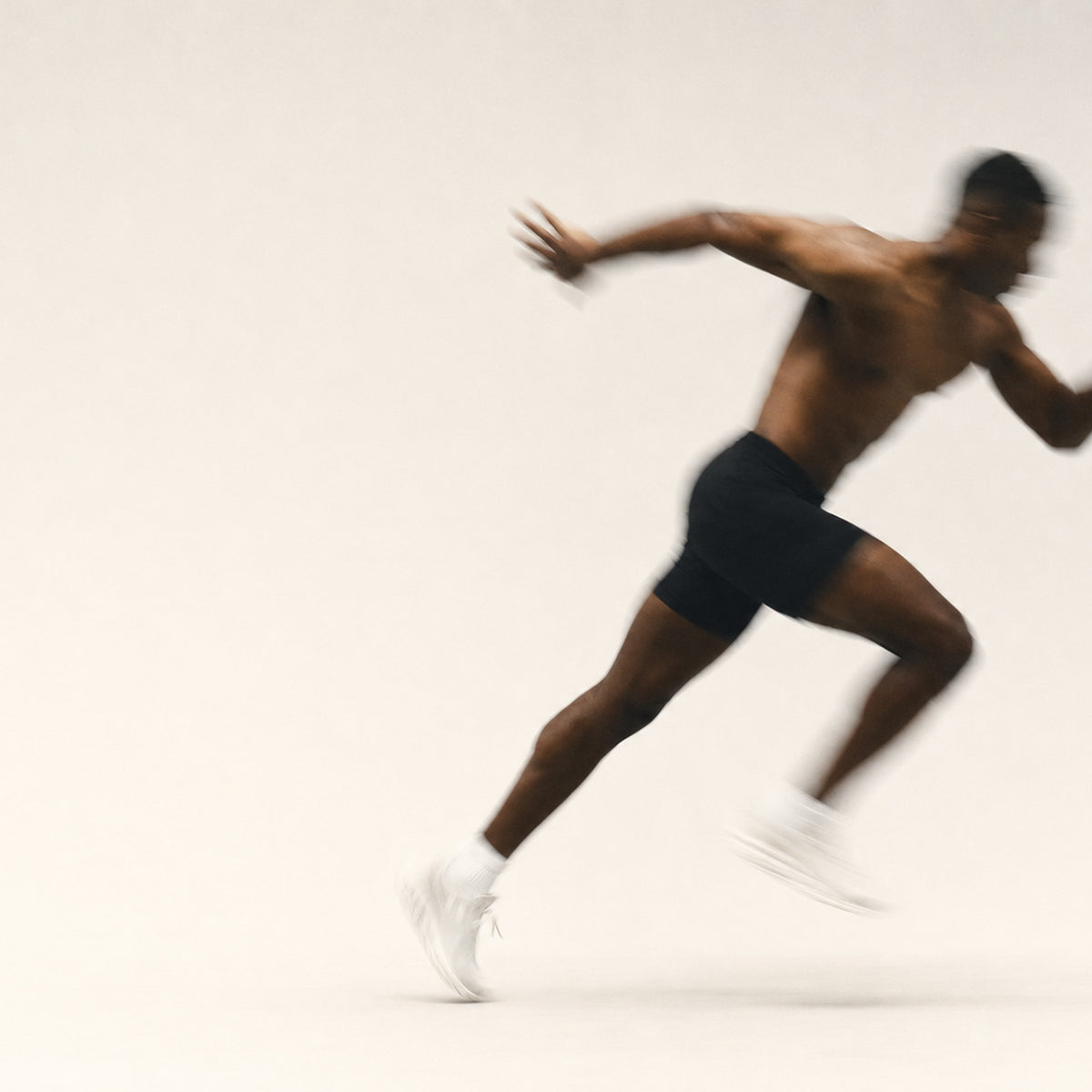An athlete sprinting, motion-blurred